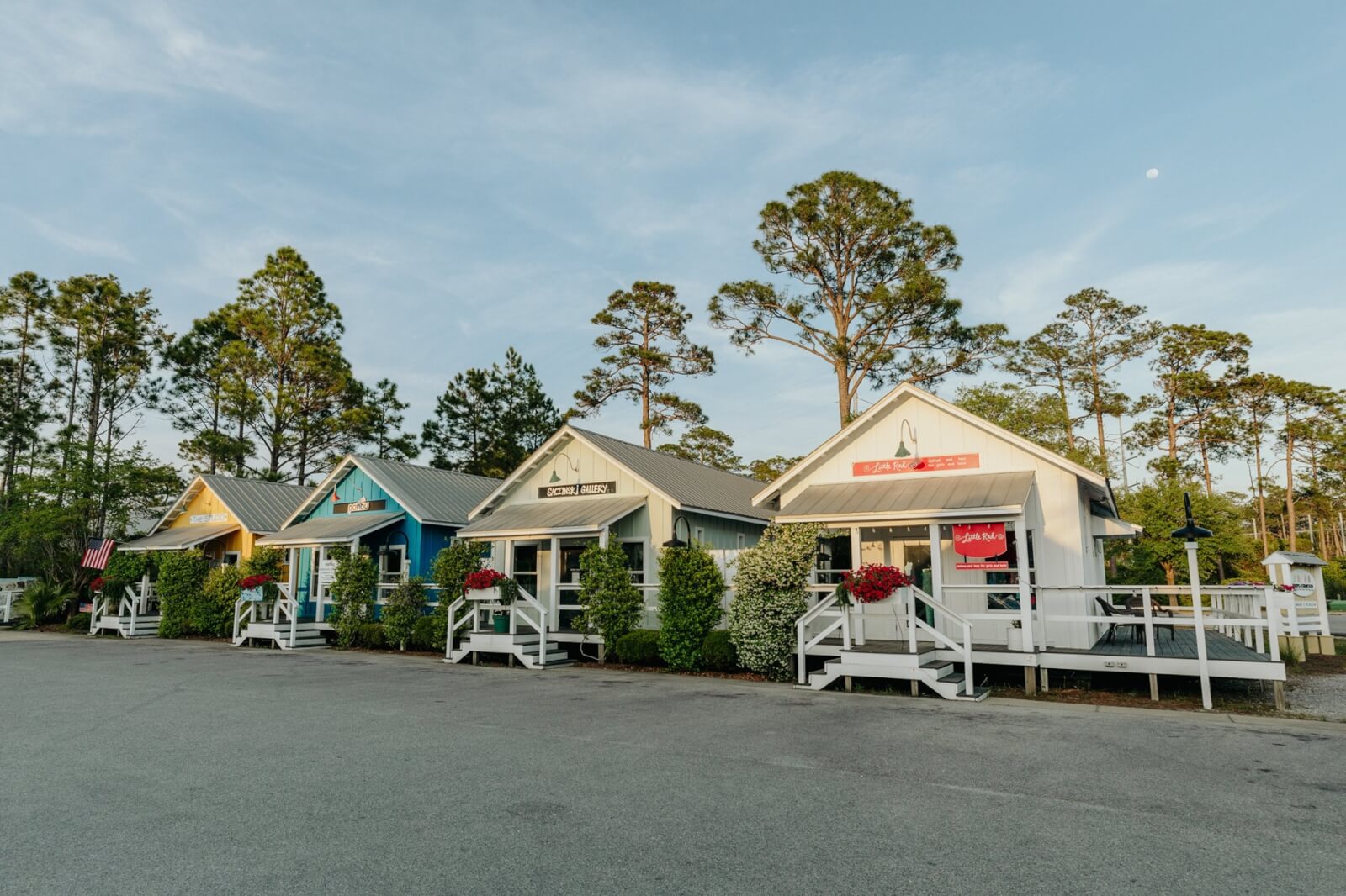 A row of colorful cottages in a parking lot.