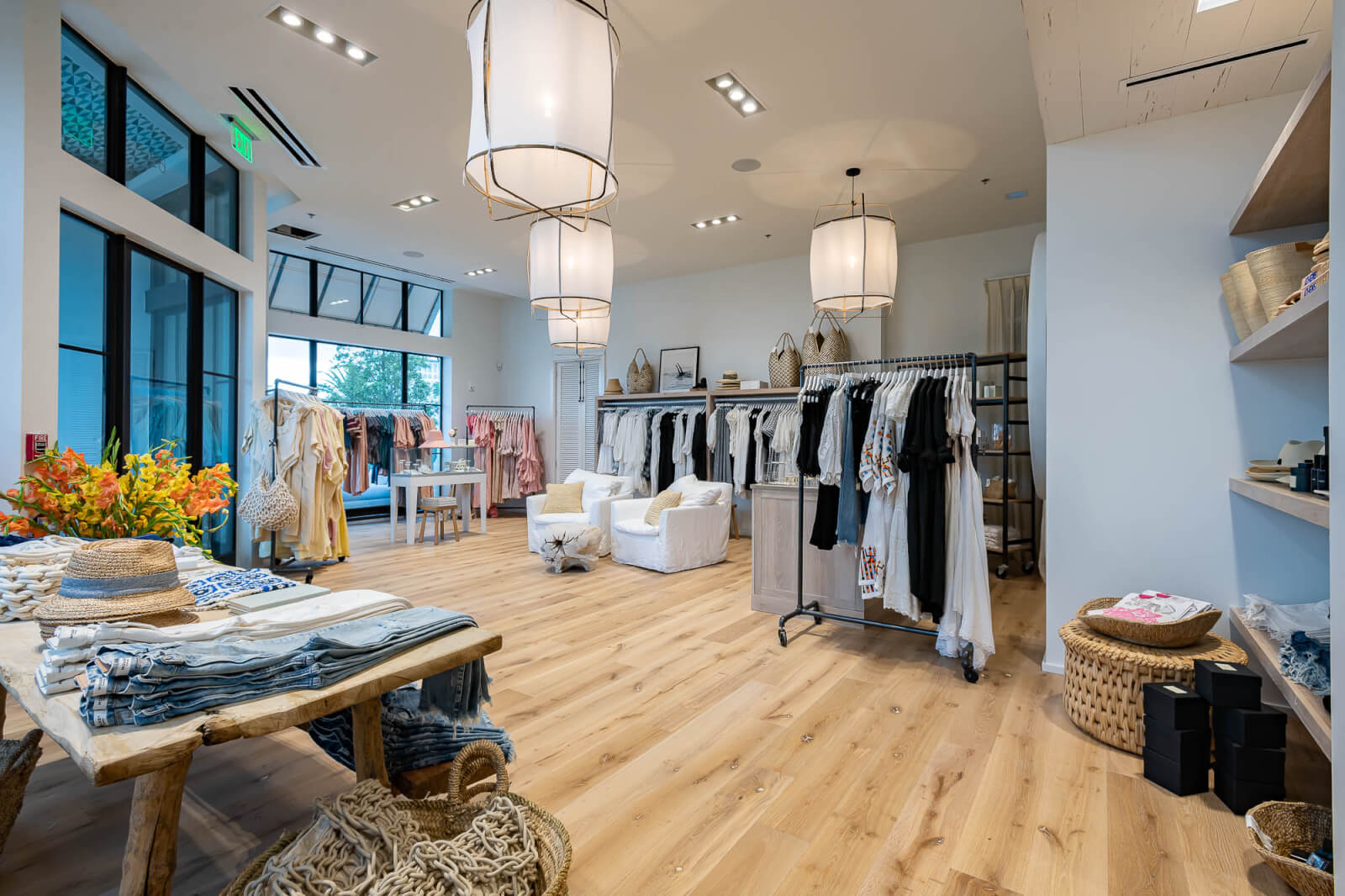 The interior of a clothing store with wooden floors.