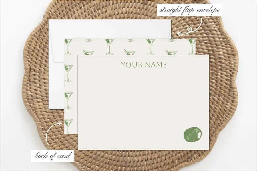 This stationery set features a straight-flap envelope and card with festive green cocktail glass illustrations and "Your Name" text on a woven mat background, perfect for holiday greetings.