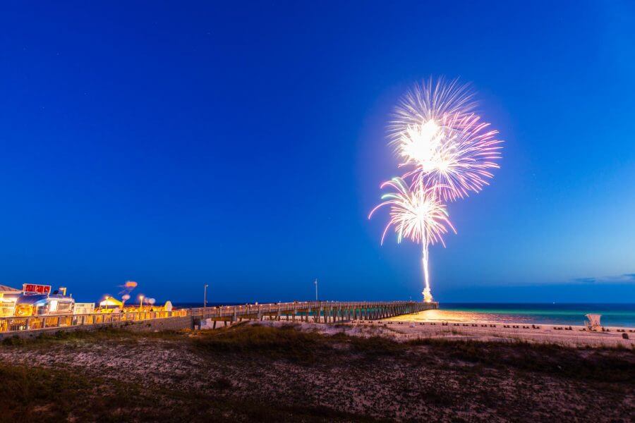 fireworks going off over the ocean in panama city beach