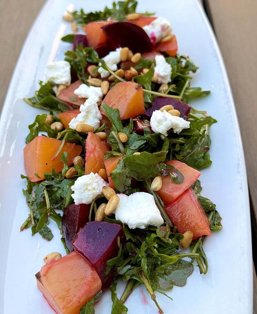 A contender for the best salads in Birmingham, this dish showcases leafy greens, cubed beets, creamy goat cheese, and crunchy pine nuts.