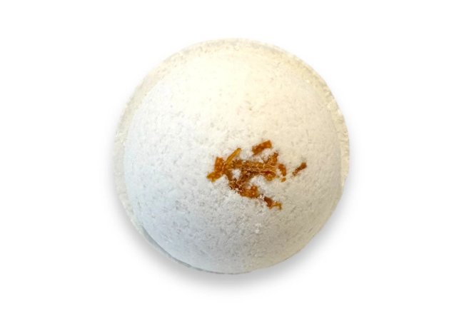 A white bath bomb featuring a delicate brown flower detail on top, reminiscent of a tranquil Memphis morning, set against a plain white background. A perfect January 2025 find for those seeking serenity in simplicity.