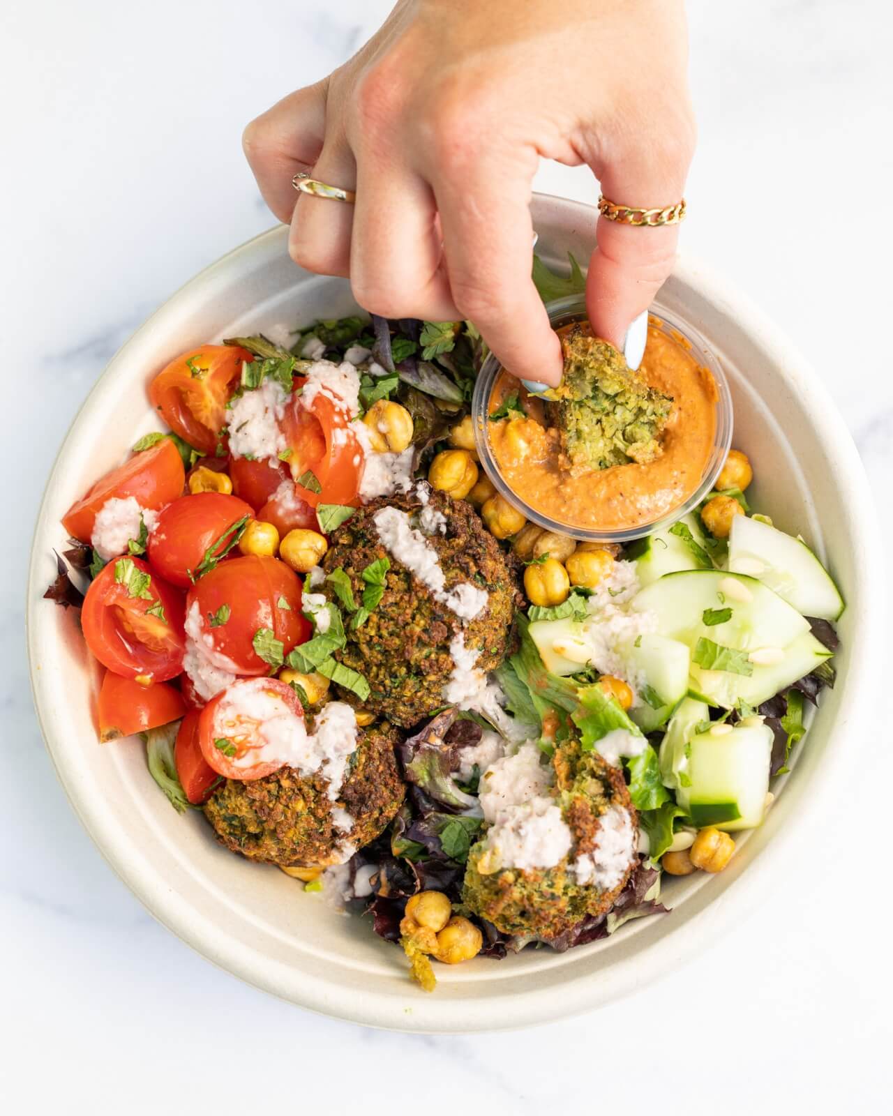 falafel salad with hand