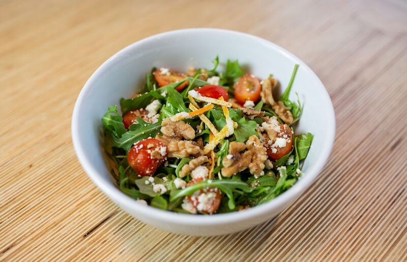 bowl of salad on wooden tabletop