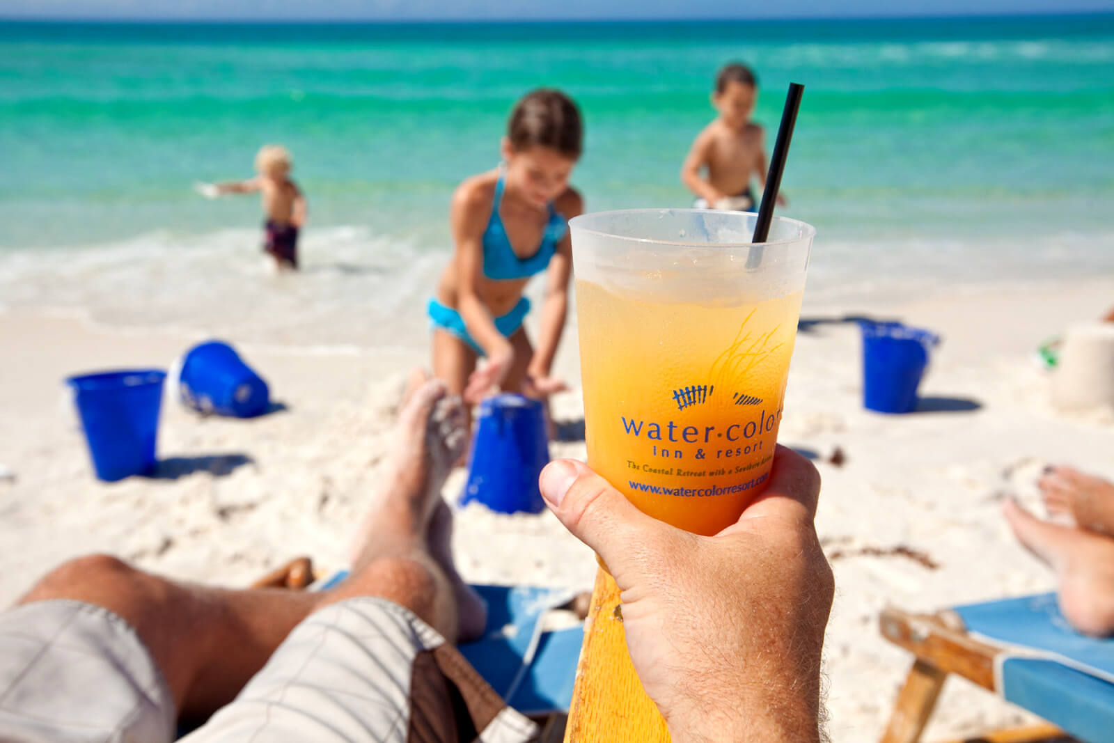 Man enjoying a frozen cocktail on the beach at the WaterColor Inn