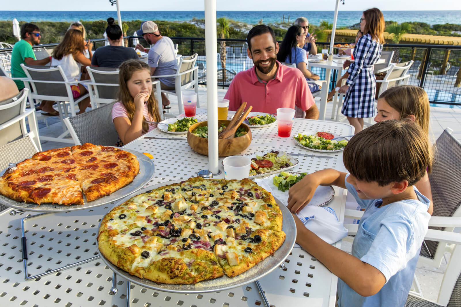 Family enjoying wood-fired pizzas at WaterColor Grill