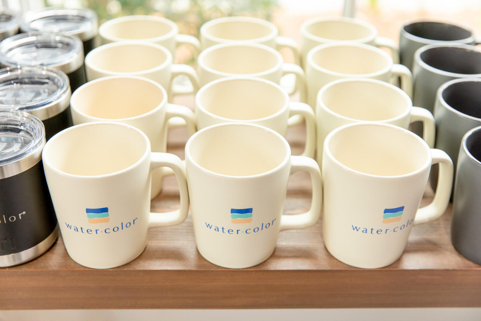 Row of white mugs from the WaterColor Store