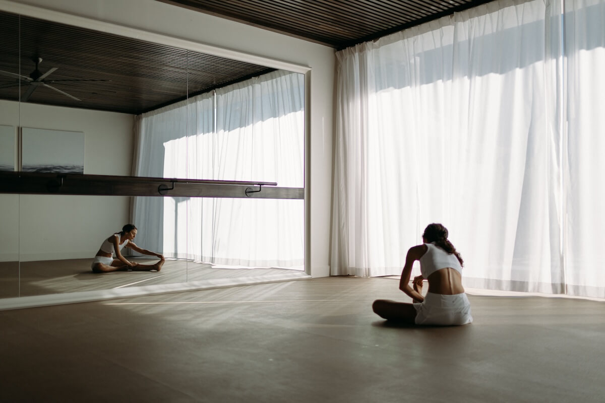 Woman doing yoga in an indoor fitness studio.