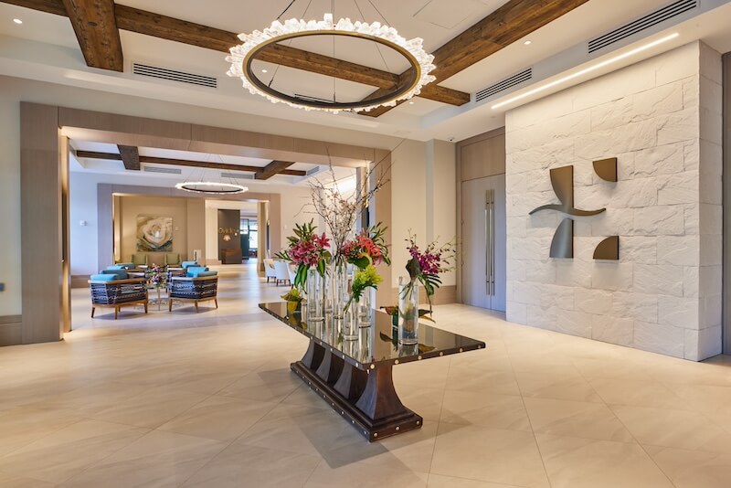 Elegant 30a hotel lobby with modern decor and a floral centerpiece.