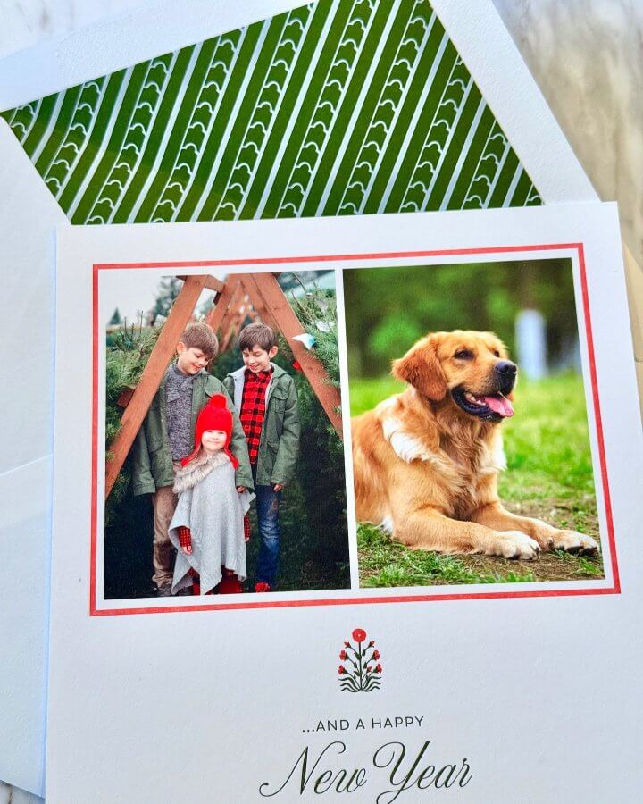 A holiday card with a festive envelope. The card features children and a golden retriever.