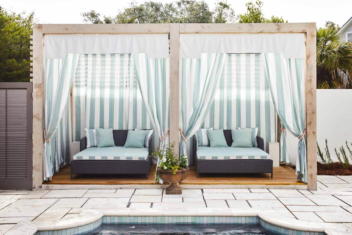 Cabanas next to swimming pool at Ashley Gilbreath's Rosemary Beach house