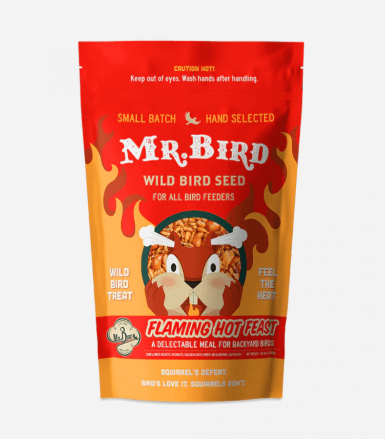 A bright red bag of Mr. Bird Flaming Hot Feast wild bird seed, featuring fiery graphics and heat warnings.