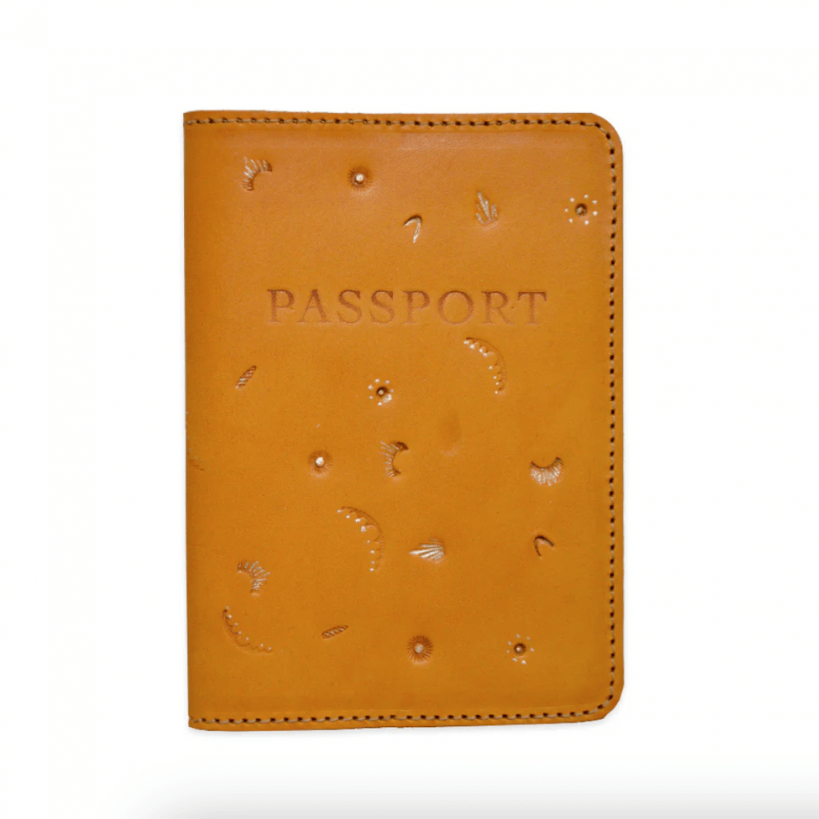 A tan leather passport holder with "PASSPORT" elegantly embossed on the cover