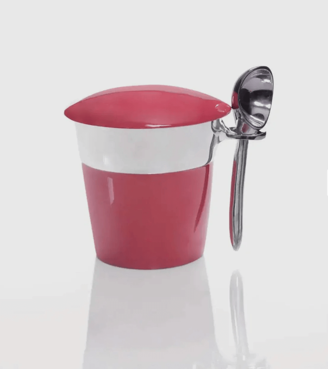 A red and white insulated cup with a stainless steel spoon artfully attached to the handle, set against a pristine white background.