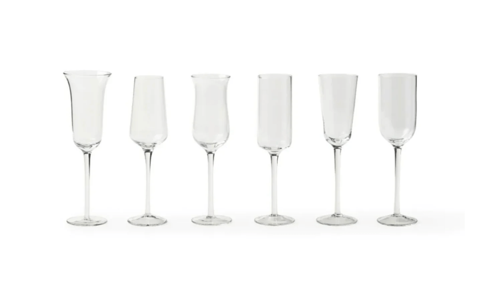 Six clear champagne flutes with varying shapes are elegantly lined up in a row on a white background