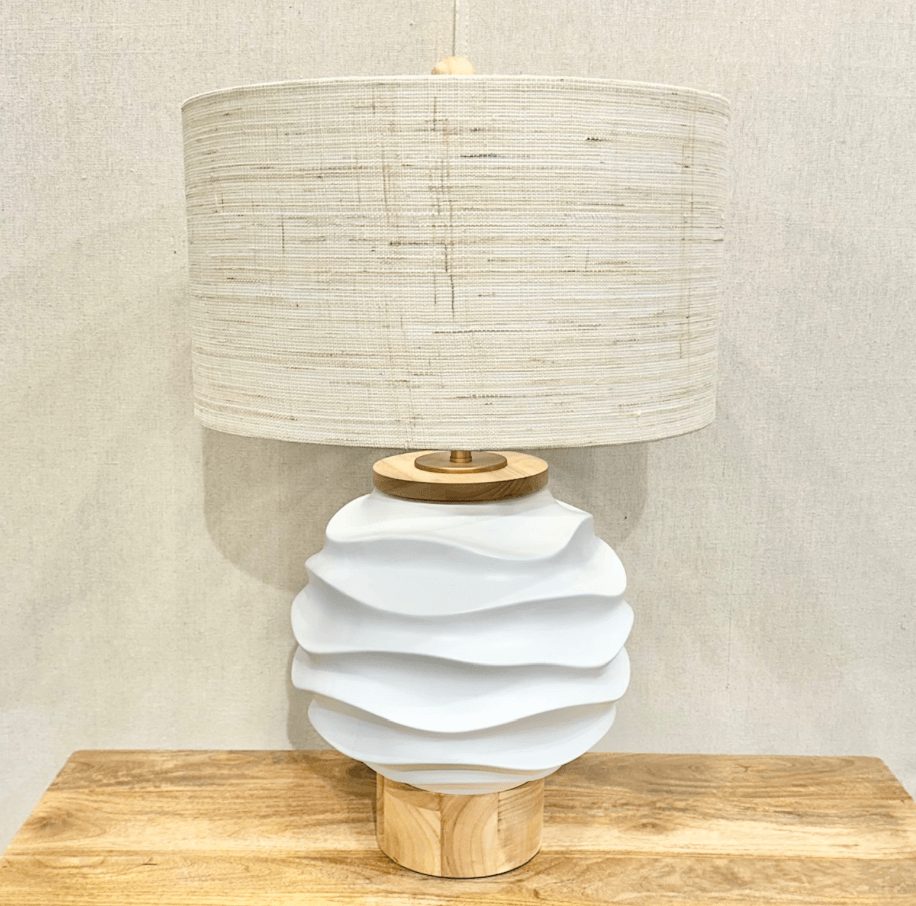 A textured white ceramic base and a cylindrical, woven beige lampshade, perfect for illuminating your Birmingham abode.