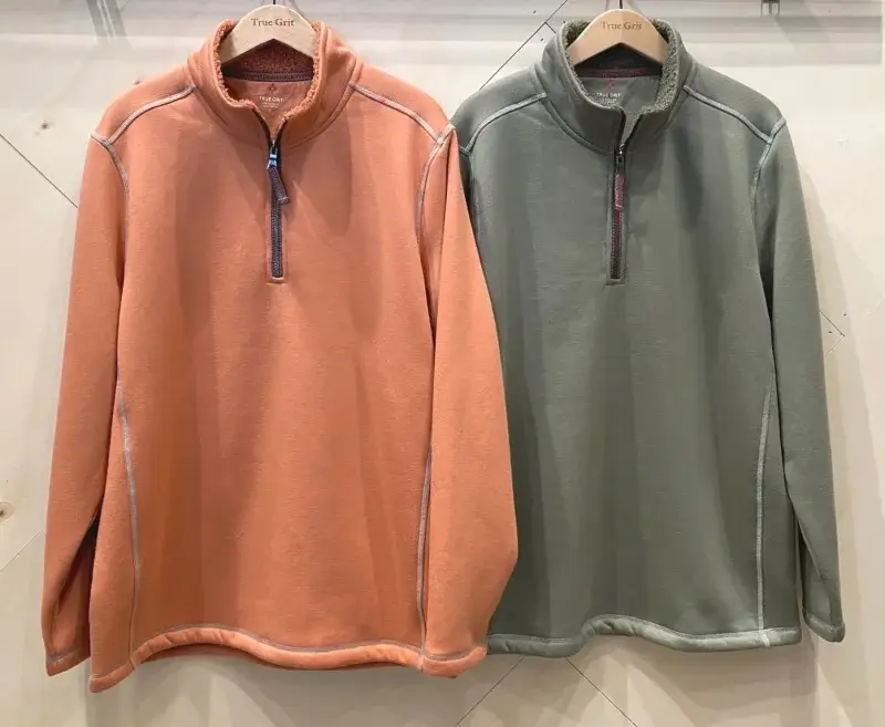 Two fleece pullovers in vibrant orange and green shades.